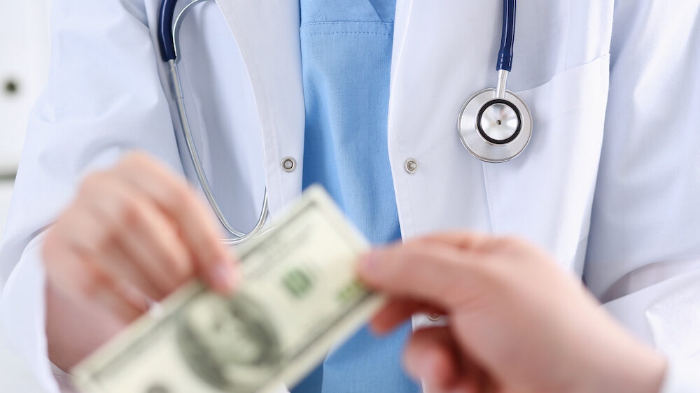 Doctor accepting cash